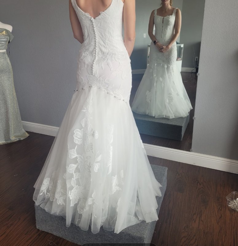 Back view of a fitted mermaid wedding gown with floral lace